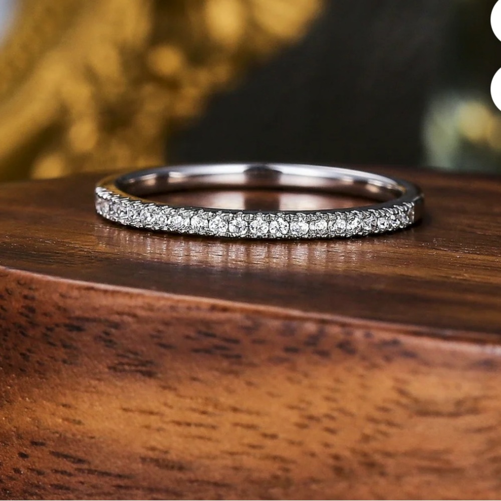 Elegant Sterling silver and moissanite pave wedding band
- 6